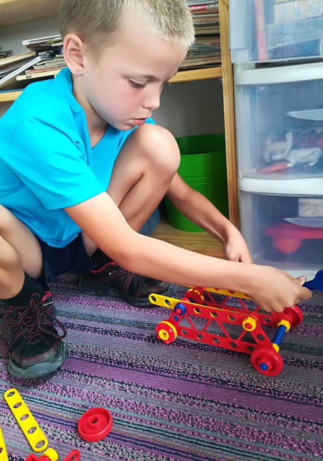 Student building a toy crane